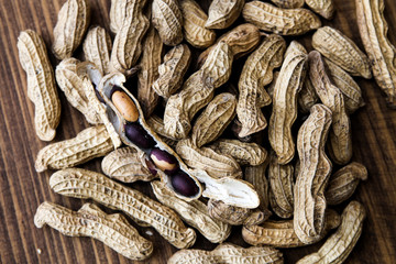 Wall Mural - Four peanuts in a shell with purple skins from a market in Tenejapa, Chiapas, Mexico