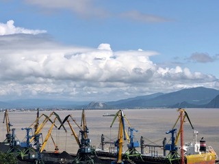 cranes in the port on the background of clouds