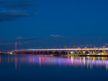 The Samuel De Champlain Bridge Linking Montreal With The South Shore Is Illuminated In Rainbow Colors On The Saint Lawrence River.