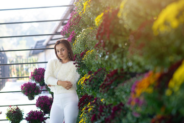 portrait beautiful woman relaxing in flower garden. Chrysanthemum flower