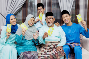 Muslim family with green envelopes