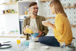 © JustLife - Young couple making breakfast at home. Loving couple enjoying in morning..