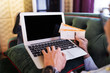 © ImageHit - Man doing an online flight check in on laptop