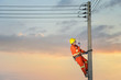 © saravut - Electricians are climbing on electric poles to install and repair power lines.electricians work with high voltage electricity.