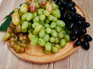 Healthy fruits. Red and green wine grapes on wooden background, dark and green organic wine grapes