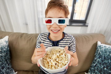 Wall Mural - people and childhood concept - happy smiling boy in 3d movie glasses eating popcorn and watching tv at home