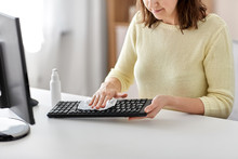 Hygiene, Cleaning And Disinfection Concept - Close Up Of Woman Spraying Hand Sanitizer To Keyboard