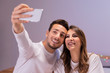© FreepikCompany - Young couple in bed taking selfie