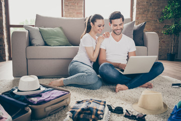 Sticker - Photo of charming lady handsome guy friendly couple stay home together packing stuff clothes planning trip after quarantine buy laptop online reservation tickets living room indoors