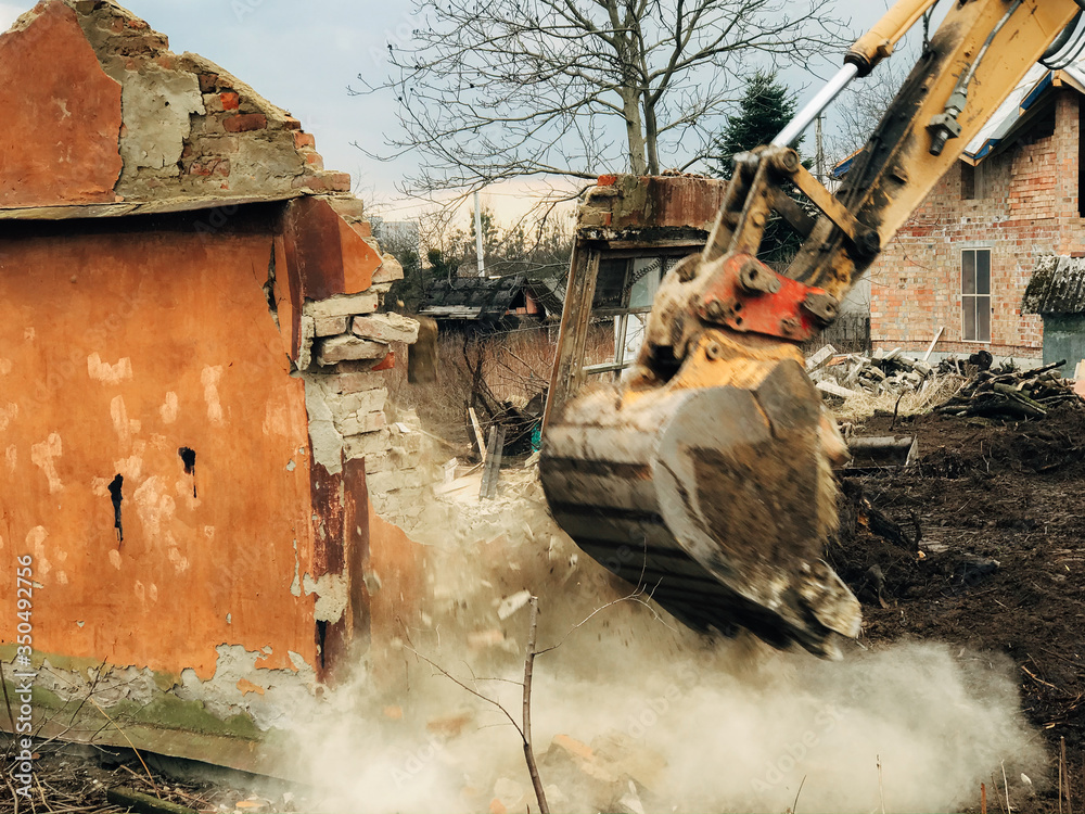 Destroying House House crushing and collapse. Excavator destroying brick house on land ...