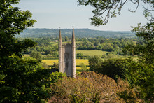 The Tower Of St Michael's Church In Mere, Wiltshire Framed By Trees, Leaves And Foliage.  Wiltshire Somerset Border Uk Countryside Landscape Scene.