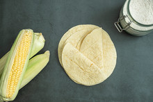 Fresh Baked Tortilla Bread, Corn Flour In Jar And Green Corn Cobs On Concrete, Stone Background. Delicious, Traditional, Healthy Food. Top View, Flat Lay Concept.