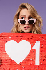 Canvas Print - Image closeup of scared blonde woman in sunglasses holding placard