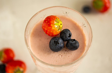 Wall Mural - Dessert strawberry panna cotta in a glass wine glass decorated with a whole strawberry and blueberry