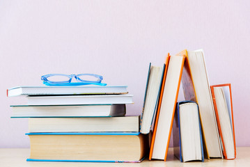 Many old books on bookshelf on simple backdrop. Copy space for your text.