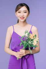 Wall Mural - Portrait of beautiful young Asian woman over violet background.