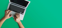 Man Hand Using Computer On Green Background