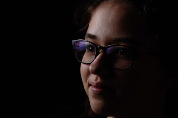 portrait on black with glasses mystery girl