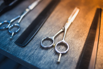 Canvas Print - combs and scissors for haircuts lie on a shelf in the cabin