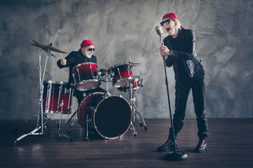 Poster - Full body photo of retired lady man rock popular band perform concert play drum instruments sing song cool mic wear trendy rocker leather outfit bandana isolated grey concrete wall background