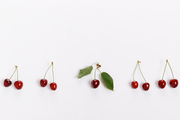 Wall Mural - Fresh bright juicy cherries on a white background, minimalistic composition, minimal theme