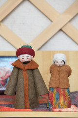 Wall Mural - Traditional national folk Mongolian art and handicraft: woolen dolls in Mongolian national ethnic costumes. Mongolian people. Crafts of Mongolia. Decorative dolls, toys. Culture of Mongolia. Souvenir