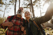 © Criene Images - Active happy senior couple hiking together in forest and exloring nature