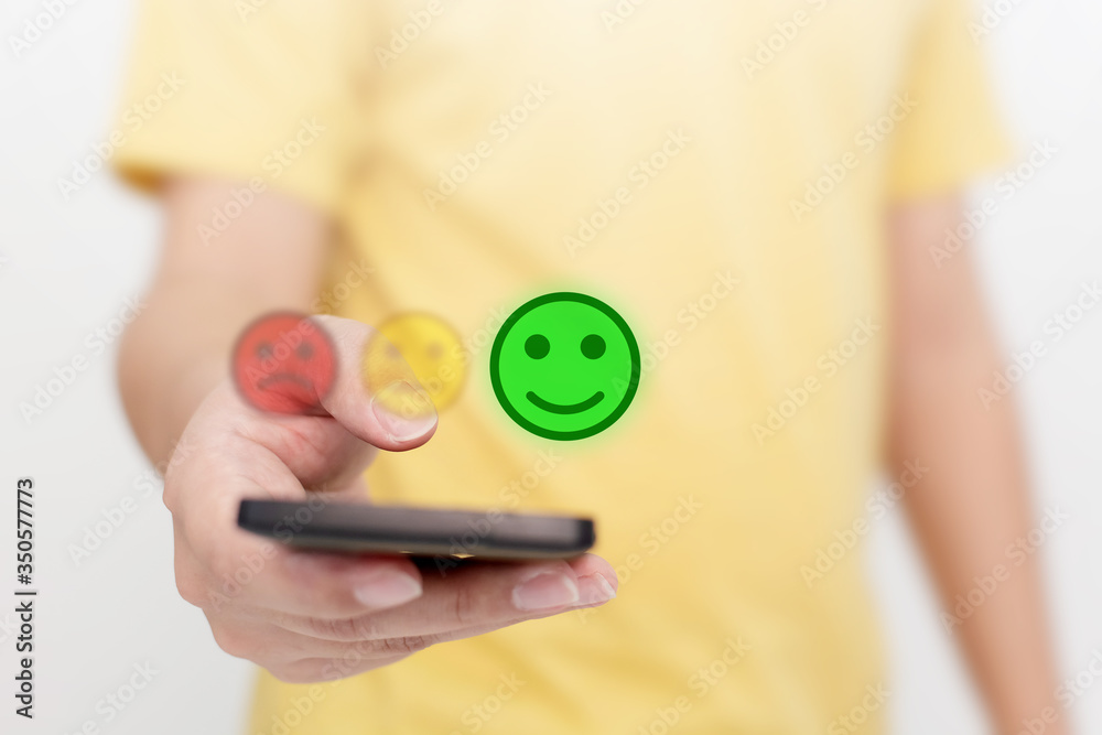 Customer Service Experience and Business Satisfaction Survey. Man choose face smile on smart phone - obrazy, fototapety, plakaty 