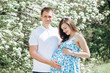 © Stanislav - Young parents walk in the park on a warm spring day. Pregnant young woman in nature. Happy future parents. Waiting for a miracle.