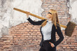 Business woman with big hammer in front of fresh start