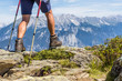 Close up of muscular and veiny male legs with trekking sticks for Nordic walking against the background of the alpine mountain range in Ziller Valley, Austria