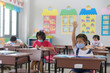 © saravut - school kids with protection face mask against flu virus at lesson in classroom