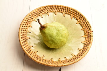 Juicy ripe, sweet, organic green pears, close-up, on a painted wooden table.