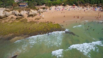 Wall Mural - Aerial photography of the coast, rock, beaches of Gale in Portugal. Tourists rest, swimming in clear, turquoise water.