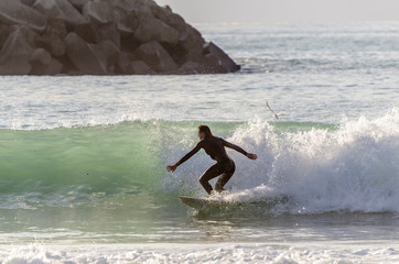 Surfer riding the waves of the sea