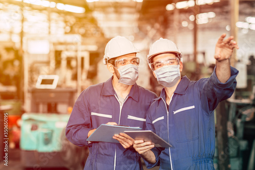 Fotomural Engineer teamwork worker wearing disposable face mask or face shield during working in factory to prevent Covid-19 virus air dust pollution and for good hygiene