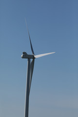 Windmill for electric power production, France. Blue sky