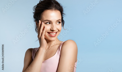 Cuadros en Lienzo Young woman with bare shoulder and shiny glowing perfect face skin laughing timid
