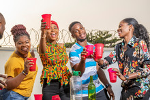 Group Of Young African Friends Having A Get Together, Make A Toast, Dancing And Having Fun