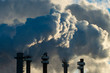 © Cavan Images - Smoke Stacks Pour Pollution Backlit by Sunrise
