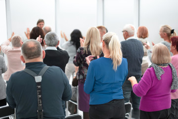 Wall Mural - Audience of adult people listen to the speech of the lecturer