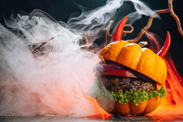 Wall Mural - Burger Halloween. halloween concept of a burger with big beef patties with pumpkin head rolls for the holiday halloween