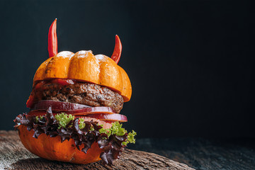 Wall Mural - Burger Halloween. halloween concept of a burger with big beef patties with pumpkin head rolls for the holiday halloween