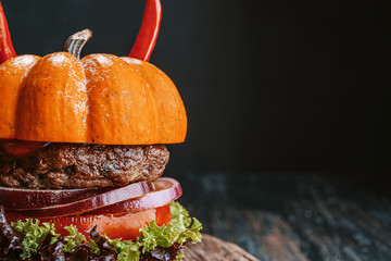 Wall Mural - Burger Halloween. halloween concept of a burger with big beef patties with pumpkin head rolls for the holiday halloween