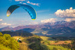 Flying paraglider from the Stranik hill over the mountainous landscape of the Zilina basin in the north of Slovakia..Mala Fatra National Park in the background, Slovakia, Europe.