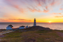 Beautiful Sunrise Over A White Lighthouse Sitting At The Edge Of A Rocky Cliff. Cape Spear National Historic Site, St Johns Newfoundland.
