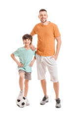 Poster - Father and little son with soccer ball on white background