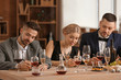© Pixel-Shot - People tasting wine at the restaurant