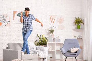 Poster - African-American teenager dancing at home