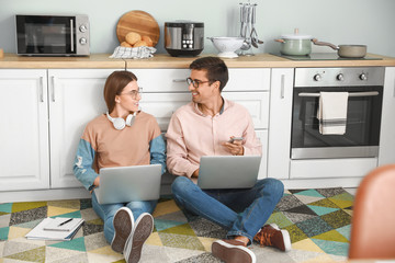 Sticker - Young couple working together at home